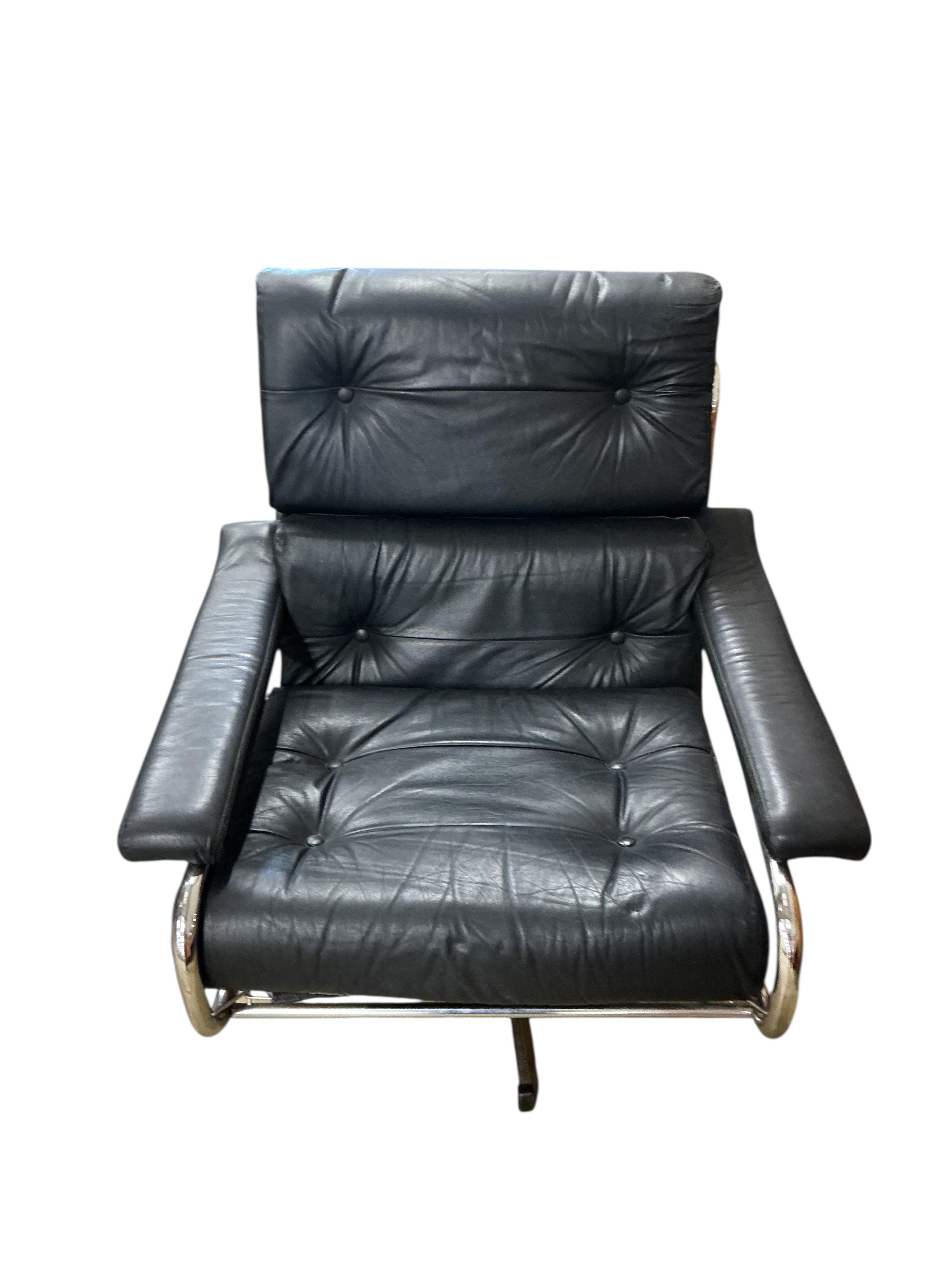 A near pair of mid century Pieff black and green leather swivel lounge chairs on chrome five prong bases, width 86cm, depth 94cm, height 91cm, one with a footstool